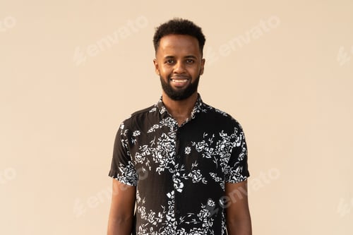 Preview: Portrait of handsome young African man against plain background