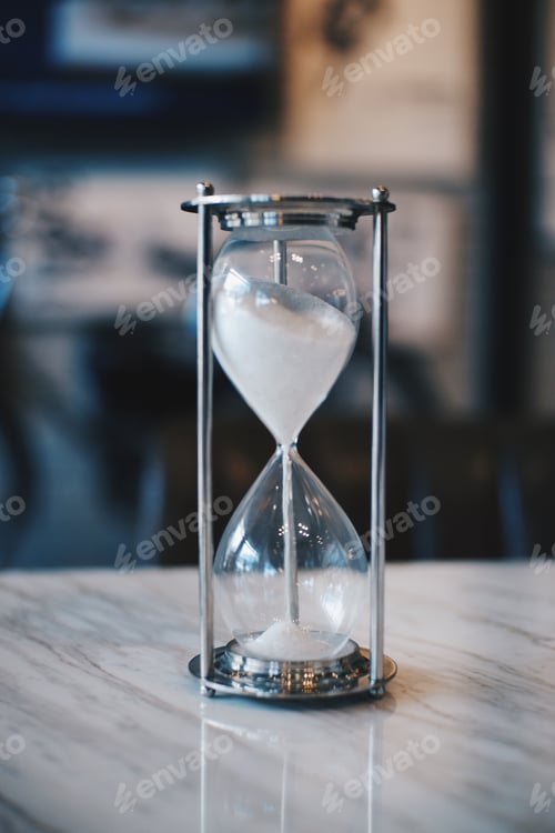 Preview: Sand running through the bulbs of an hourglass measuring the passing time