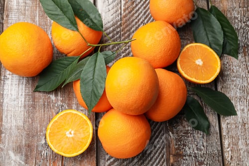 Preview: Fresh oranges and leaves on wooden table, flat lay