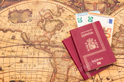 Preview: Spanish passport with euro bills inside, on a world map for travelers.