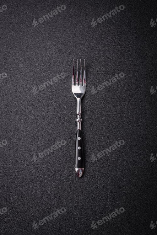 Preview: Kitchen fork made of steel on a dark textured background