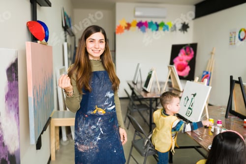 Preview: Portrait of a pretty teacher in a art classrom for children