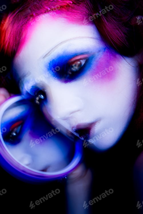 Preview: High Fashion model woman in colorful bright lights posing in studio
