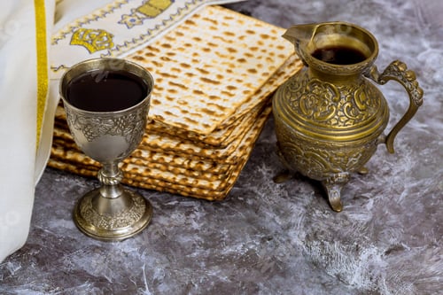Preview: Traditional Passover Seder table setting with matzah, wine cup at Jewish Holiday