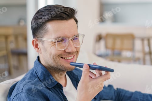 Preview: A jovial man talks on the phone, his warm smile reflecting a comfortable, laid-back ambiance.
