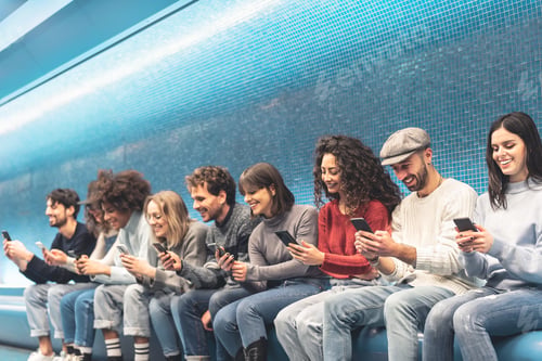 Preview: Happy friends using mobile smartphone in underground station