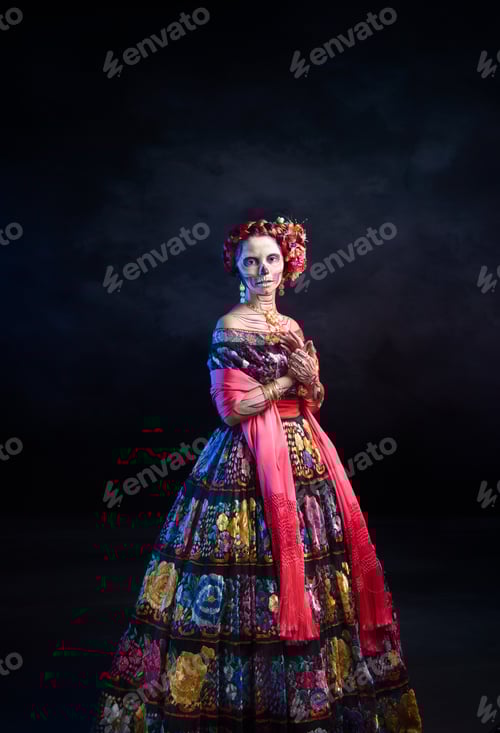 Latina woman dressed as a Mexican Catrina, with bold skull makeup