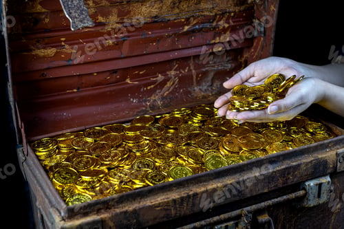 Preview: Lots of stacking Gold Coin in lady hand and treasure chest