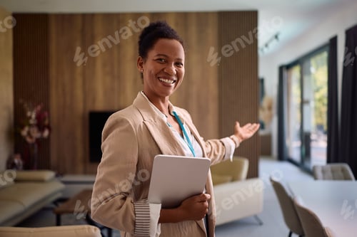 Preview: Happy black real estate agent showing a new house for sale and looking at camera.