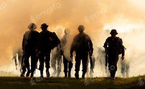 Preview: Silhouette of soldiers walking against smoke and sunset background.