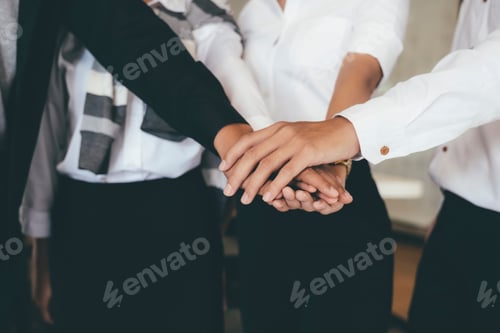 Preview: Business people join their hands together in teamwork concept