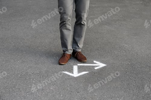 Preview: Man standing near arrows on asphalt. Choice concept