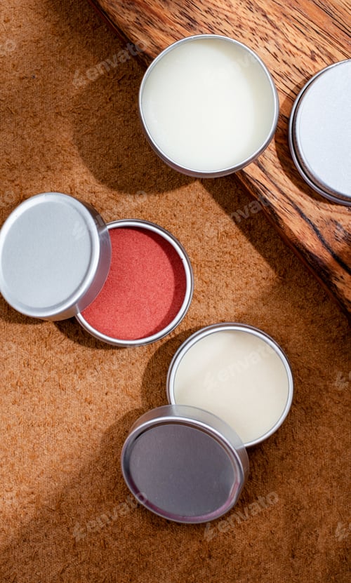 Preview: colorful lip balms in round tin cases on leather with shadow overlay, mockup design