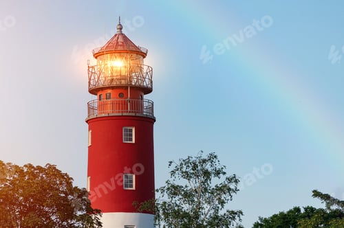 Preview: Lighthouse in Baltiysk port. Beautiful rainbow and beacon lights. Clean blue sky, copy space.