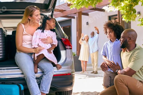 Preview: Grandparents Greeting Grandchildren As Family Unpack Car On Family Holiday