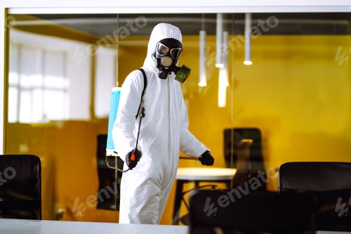 Preview: Disinfecting of office to prevent COVID-19, Man in protective hazmat suit with spray chemicals.
