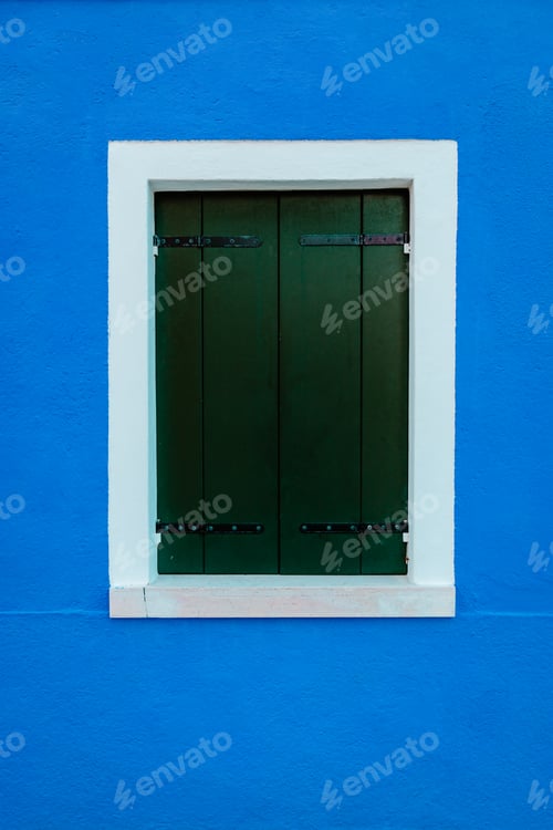 Preview: Window with white borders on blue dwelling wall