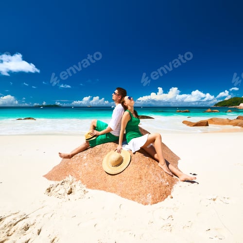 Preview: Couple In Green On A Tropical Beach At Seychelles