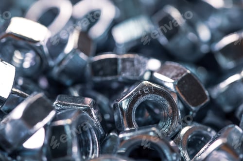 Preview: Metal chrome nuts in a chaotic order industrial background