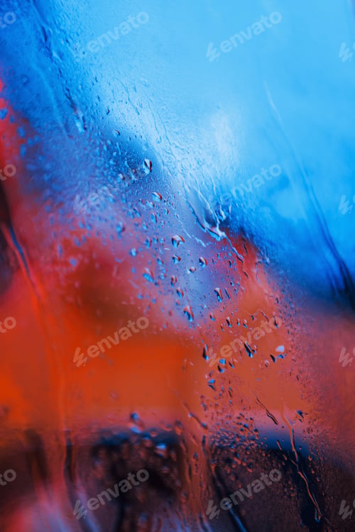 Preview: Water droplets on neon glass background. Red and blue colors