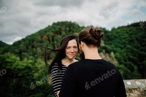 Preview: Happy Couple in a Forested Setting Smiling
