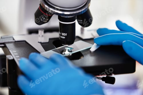 Preview: close-up of scientist hands with microscope, examining samples and liquid.