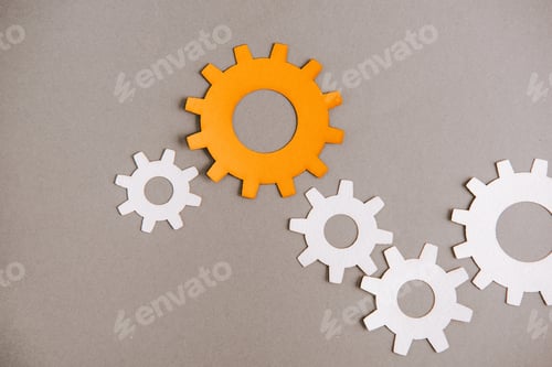 Preview: top view of white and orange gears on grey background
