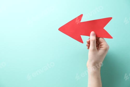 Preview: Woman with paper arrow on turquoise background, top view. Space for text