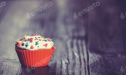 Preview: Cupcake on wooden table.