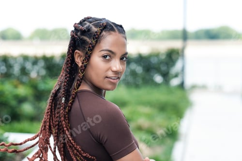 Preview: Natural portrait of young woman looking to camera.