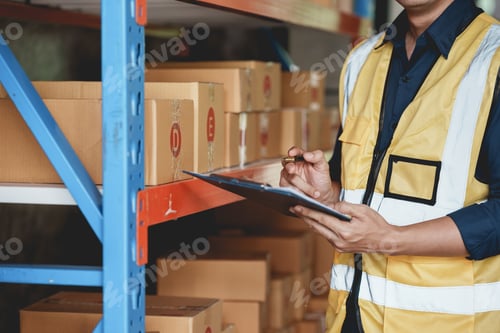 Preview: Male warehouse check worker checking and counting inventory accurately and tidy by balance.