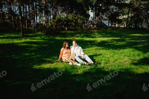 Preview: Couple enjoying a sunny afternoon in a serene forest clearing