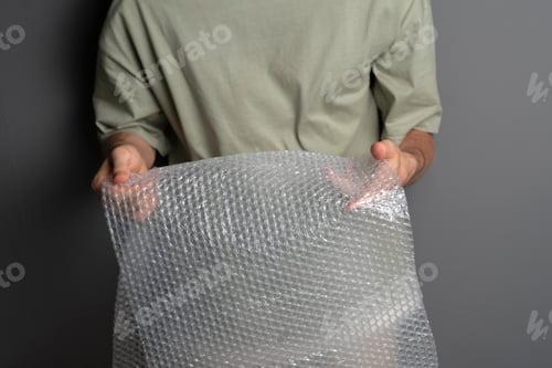 Preview: a person holding and bursting bubble protective wrap trying to calm down