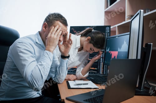 Preview: Team of stockbrokers are having a conversation in a office with multiple display screens