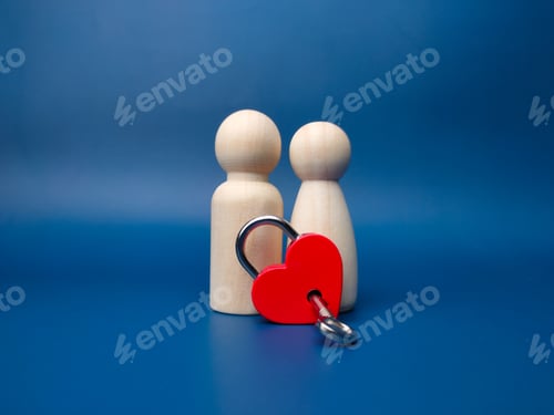 Preview: Couple wooden peg doll with love padlock and key on a blue background.