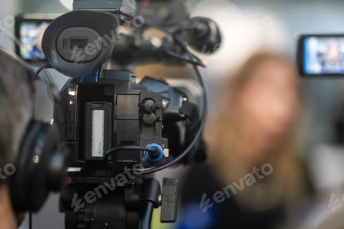 Preview: Media camera stands poised, capturing the dynamic energy and captivating details of an event.