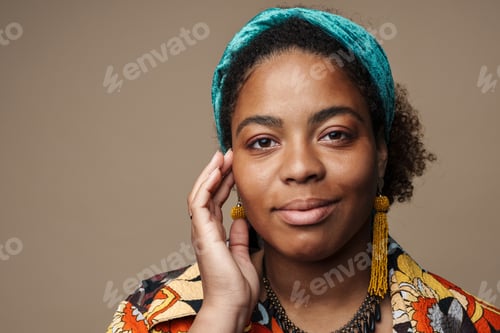 Preview: Young black woman in headband smiling and looking at camera