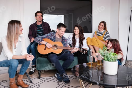 Preview: Group of friends at a home party playing music together and having fun in the living room
