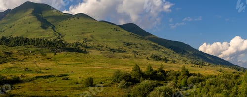Preview: Panoramic View of Lush Green Hills Under Blue Sky