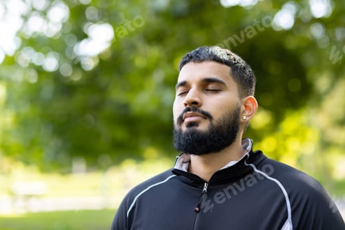 Preview: Man in contemplation at serene park setting
