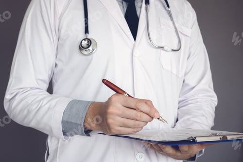 Preview: Doctor writing a medical chart.
