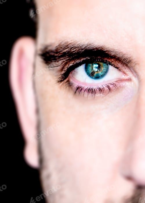 Preview: Close up of half a mans face with colorful eye iris.