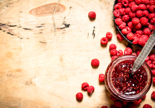 Preview: Sweet raspberry jam in jar with spoon.