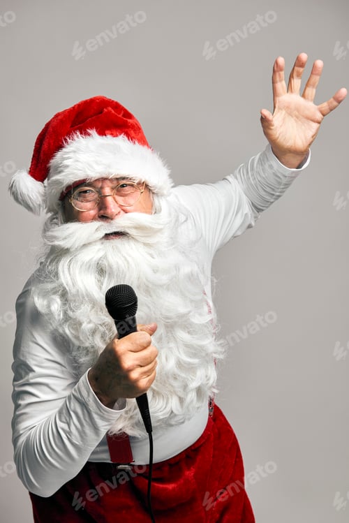 Preview: Caucasian Santa Claus singing and dancing on the grey background