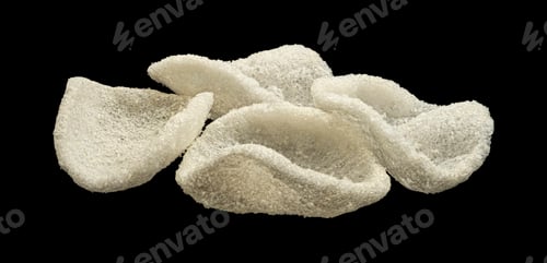 Preview: Japanese prawn crackers isolated on black background, traditional Asian snack, full depth of field