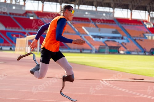 Preview: Asian para-athletes with prosthetic blades sprint on a running track at stadium.