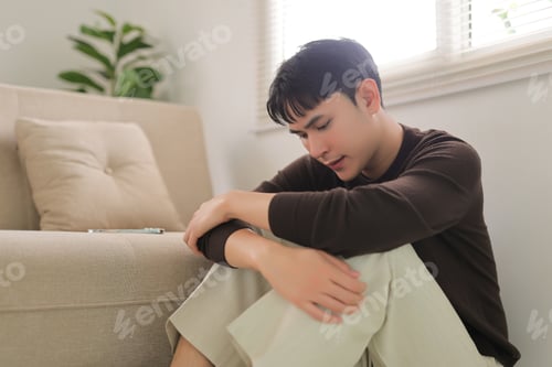 Preview: Sad young man dealing with depression and loneliness
