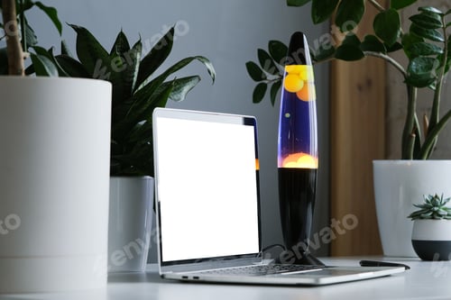 Preview: Yellow and blue lava lamp standing on working desk with plants in the office or home