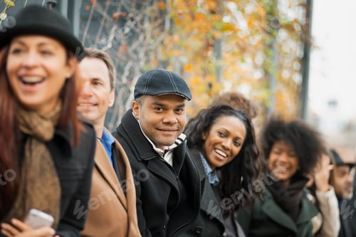 Preview: A group of people standing in a line. Looking up and laughing.