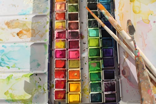 Preview: Creative mess in artistic workshop. Empty canvas, acrylic paints, brushes, pencils, palette knife.